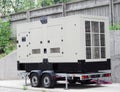 A white generator set trolley, a towable and standalone, mobile, portable industrial natural gas generator unit on four wheels