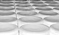 White generic plastic containers with lids lined up in rows.