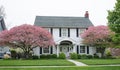 White Georgian Colonial House with Large Flowering Crab Apple Trees Royalty Free Stock Photo