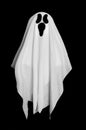 White Ghost From The Blanket On Black Background. Halloween Decoration.