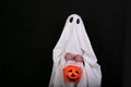 White Ghost with a knife in blood on black background. Halloween holiday party.