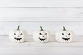 White ghost pumpkin on white wood table with copy space , halloween concept