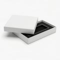 White gift box with black interior and open lid isolated on white background Royalty Free Stock Photo