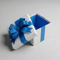 A white gift box with a blue ribbon and bow on top Royalty Free Stock Photo