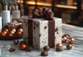 White gift box with brown ribbon is decorated with chocolate truffles and anise stars Royalty Free Stock Photo