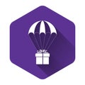 White Gift box flying on parachute icon isolated with long shadow. Delivery service, air shipping concept, bonus concept Royalty Free Stock Photo