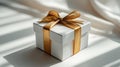 White gift box with gold ribbon on white smart background Royalty Free Stock Photo