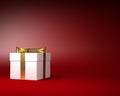 White Gift Box with Gold Ribbon and Bow on the Red Background Royalty Free Stock Photo