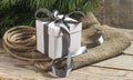 White gift box with grey ribbons, cristmas tree branch and rope Royalty Free Stock Photo