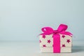 White gift box with pink star pattern and pink ribbon bow Royalty Free Stock Photo