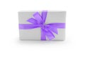 White gift box with purple ribbon bow isolated on white background Royalty Free Stock Photo
