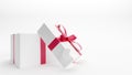 White gift box with red ribbon on white background