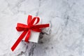 White gift box with red ribbon bow on marble background. holidays and celebration concept. copy space. present for Royalty Free Stock Photo