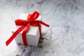 White gift box with red ribbon bow on marble background. holidays and celebration concept. copy space. present for Royalty Free Stock Photo