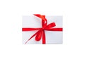 White gift box with red ribbon and bow isolated on white background top view close up Royalty Free Stock Photo