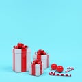 White gift box red ribbon stack among candy in blue background. Minimal Christmas concept idea Royalty Free Stock Photo