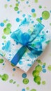 a white gift box with sky blue bow on green blue dot on white background Royalty Free Stock Photo