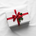 White gift box on a smooth white surface wrapped with a shiny Royalty Free Stock Photo
