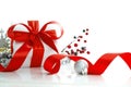 White gift box tied red ribbon bow and Christmas baubles Royalty Free Stock Photo