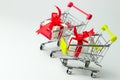 White gift box tied with red ribbon in two shopping carts Royalty Free Stock Photo