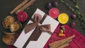 White gift box on wooden background, berries, cinnamon, autumn m