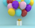 The white gift box with yellow ribbon and colorful balloons floating on blue color background. minimal merry christmas and new ye Royalty Free Stock Photo