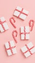 White gift boxes wrapped with red and white striped ribbons on a white background, studio lighting. Royalty Free Stock Photo
