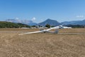 White glider is on the airport on the mountain background Royalty Free Stock Photo