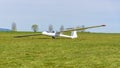 White glider on the grass airfield Royalty Free Stock Photo