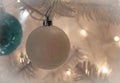 White, glittery Christmas Ornament on a white Christmas Tree