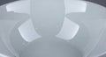A white, glossy ceramic bowl with a smooth, reflective surface is shown. The interior is evenly Royalty Free Stock Photo