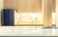 White glossy counter top and blur kitchen room background