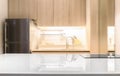 White glossy countertop and on blur kitchen room background