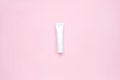 White glossy plastic tube for medicine or cosmetics, cream, gel, skin care, toothpaste on pastel pink background. Beauty cosmetics Royalty Free Stock Photo