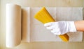 A white-gloved hand places raw spaghetti on a paper towel.