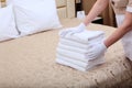 The white-gloved hands of a maid are tidying up a bedroom in an expensive hotel. The concept of the hotel business. Top view Royalty Free Stock Photo