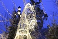 White glowing lights garlands in the shape of a horse`s head of Russian Troika on the street.