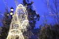 White glowing lights garlands in the shape of a horse`s head of Russian Troika on the street.
