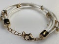 a couple of white and gold bracelets on a table Royalty Free Stock Photo