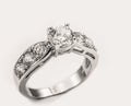 White gold diamond ring on white cream background