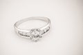 White gold diamond ring on white cream background