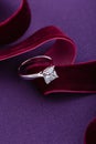 White gold engagement ring with big diamond on purple background Royalty Free Stock Photo