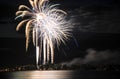 White and gold fireworks celebration over lake Royalty Free Stock Photo