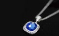 White gold necklacenSet with blue gemssurrounded by diamonds Royalty Free Stock Photo