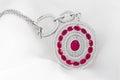 White gold pendant with diamonds and rubies on soft white background Royalty Free Stock Photo