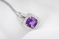 White gold pendant with rose violet amethyst and diamonds on soft blurred background Royalty Free Stock Photo