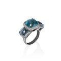 White gold ring with blue topaz and multiple diamonds, cushion cut gems Royalty Free Stock Photo