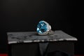 White gold ring with a large stone on a gray box Royalty Free Stock Photo