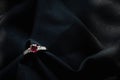 White gold ruby and diamond ring  on black fabric background Royalty Free Stock Photo