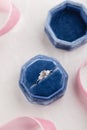 White golden wedding ring with diamonds in blue vintage velvet b Royalty Free Stock Photo